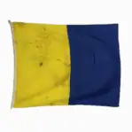Letter K Kilo nautical signal flag with yellow and blue vertical sections and heavy dirt from sea use