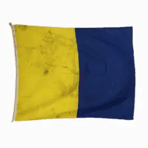Letter K Kilo nautical signal flag with yellow and blue vertical sections and heavy dirt from sea use