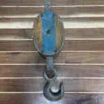 Top-down view of nautical double pulley with visible hook and blue stripe