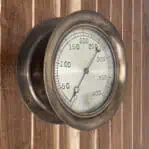 Vintage Brass Steam Gauge - Cleveland Gauge Co. on the wall