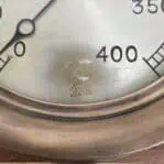 showing the wear on the face of the steam gauge