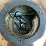 Inside view of large copper nautical light showing wiring and socket