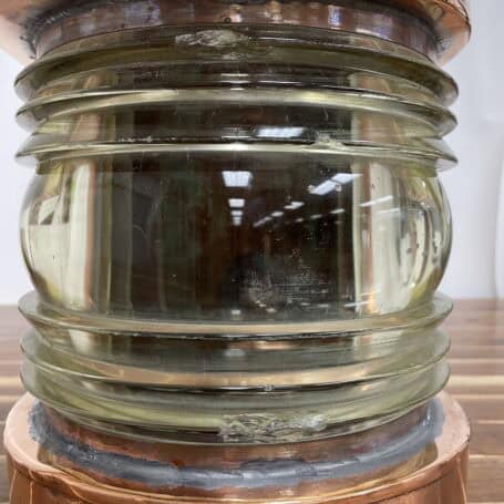 Vintage Large Copper Nautical Light - Made by C.M. Hammar 07 Close-up of Fresnel lens on large copper nautical light with chips visible