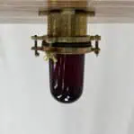 Brass Nautical Ceiling Light with Red Globe on the ceiling