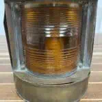 showing the fresnel glass on the Brass Navigation Light with Orange Fresnel Lens