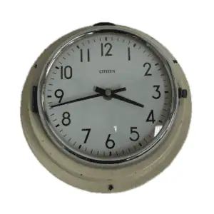 Front view of a vintage Citizen nautical wall clock with cream metal housing and black numerals on a white face