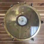 Brass pendant light with patina — view of glass lens and ceramic socket