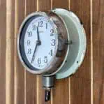 Side angle (1): Side angle of nautical clock with original conduit wiring, showing conduit exit at lower base