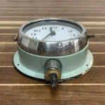 Bottom angle: Bottom view of nautical clock with original conduit wiring, highlighting cut conduit section