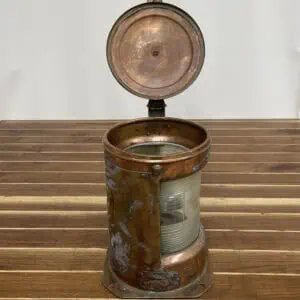 Isolated image of copper Fresnel lens navigation light on white background for product display.