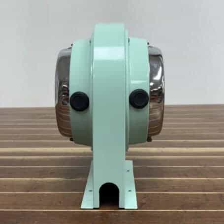 Salvaged Double-Sided Ship Clock by Citizen Side angle: Side angle of Salvaged Double-Sided Ship Clock showing chrome rings and steel body