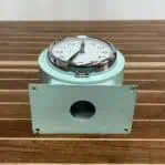 Bottom view showing the clock’s mounting hardware for secure wall installation.