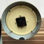 Clock Mechanism: Inside view of the rewired quartz mechanism, powered by AA batteries.