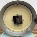 Close-up of clock mechanism with quartz movement inside 6. Top view showing metal frame and wear from ship use