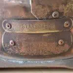 Close-up of brass maker's plate on vintage copper starboard navigation light showing “Starboard” and “All Round White” labels.