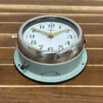Bottom angle - Bottom angle of vintage ship wall clock highlighting light blue-grey finish