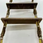 Looking up from bottom: View from below showing weathered steps and rope clamp detail