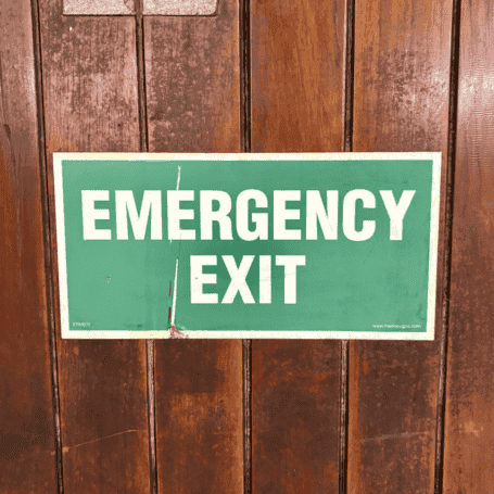 Salvaged Ship Door with Porthole (2) Close-up of green and white emergency exit sign on ship door