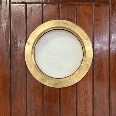 Salvaged Ship Door with Porthole (6) Salvaged Ship Door with Porthole close-up of brass porthole window