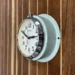 Side angle of Seiko Seafoam Wall Slave Clock showing enamel body and corrosion