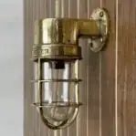 Side view: Side profile of solid brass dock light with classic shape.