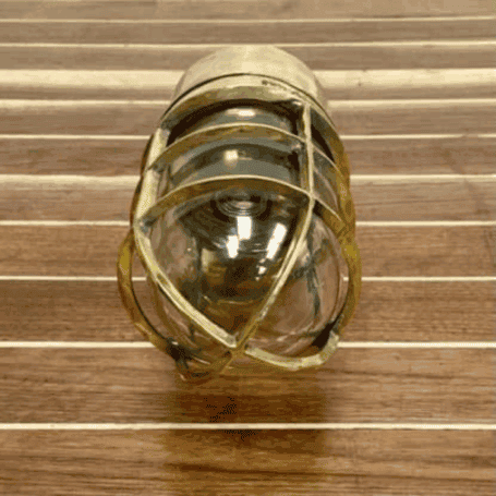Solid Brass Dock Light (4) Bottom view: Upward angle showing the glass lens and interior bulb socket through the protective brass cage Bottom view: Upward angle showing the glass lens and interior bulb socket through the protective brass cage