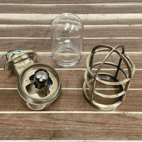 Solid Brass Dock Light (6) Disassembled: Light disassembled into parts to show lens, cage, and interior wiring