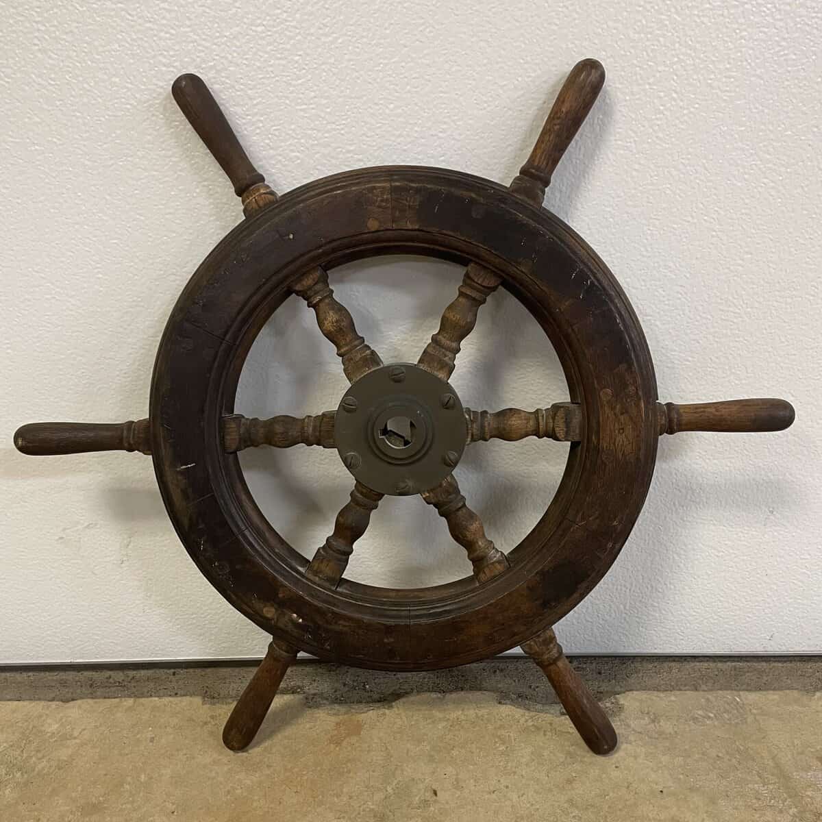 Reverse side of the vintage wood ship wheel showing the back of the steel hub and wood grain details