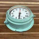 Top Angle: Top view showing curvature of the clock’s case and surface wear