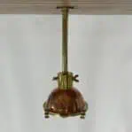 Copper and Brass Nautical Pendant Light mounted to ceiling with downrod and brass hardware