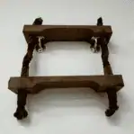 Wall-mounted nautical rope ladder section used as compact shelf display