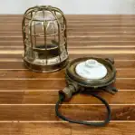 Disassembled parts showing brass cage, globe, and fixture base