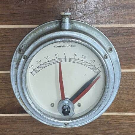 Vintage Nautical Clinometer - Kompas Rijeka Yugoslavia Ship Instrument Nautical clinometer by Kompas Rijeka with red and black hands displayed on wood background