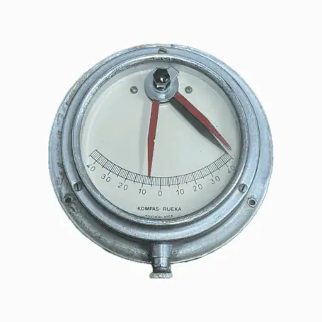 Close-up of vintage nautical clinometer marked Kompas Rijeka Yugoslavia
