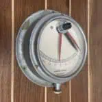 Angled view of Kompas Rijeka nautical clinometer with visible wear and grime