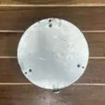 Back view of aluminum ship instrument showing mounting holes and wear