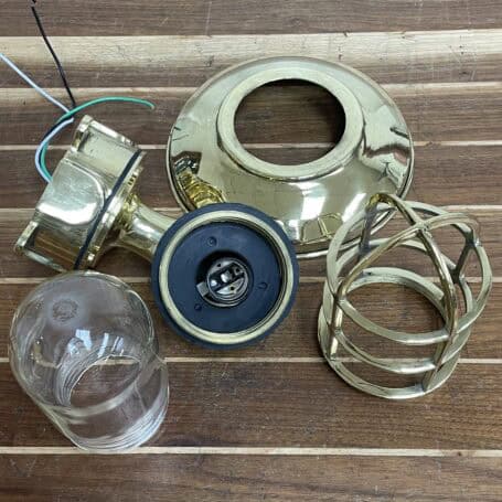 Nautical Wall Sconce - Brass (Brass Cover) Brass nautical wall sconce disassembled, displaying internal wiring and parts