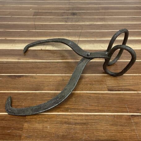 Vintage Iron Ice Tongs - Recovered from Lake Erie, Lorain Ohio (2) Side angle of vintage iron ice tongs resting on a wooden deck.