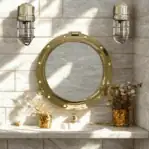 Nautical-style bathroom with round porthole mirror and brass lighting installed