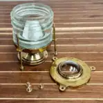 Marine-style brass light disassembled to show glass globe and hardwar