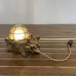 Side view of brass industrial table lamp showing twisted cloth cord
