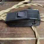 Close-up of inline switch and cloth-wrapped electrical cord