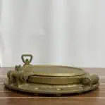 Side view of iron ship porthole showing hinge and locking mechanism