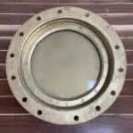 Iron ship porthole with closed cover and gold finish backside