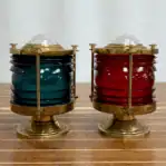 Side view of vintage maritime navigation light with red and green glass lenses