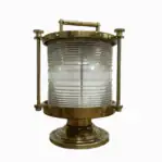 Front view of brass marine fresnel light with clear lens and patina