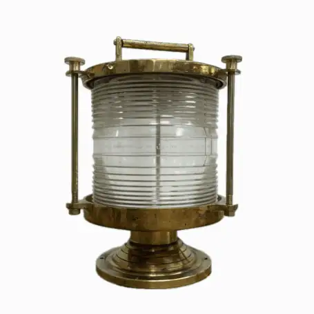 Front view of brass marine fresnel light with clear lens and patina