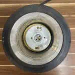 Top-down view inside the brass marine fresnel light showing socket and wiring