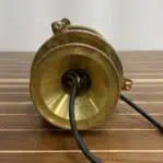 Underside wiring of a vintage ship light with thick brass base