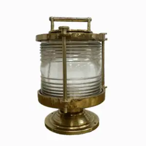 Side angle of brass ship light with clear lens and mounted base